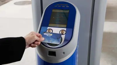 hand tapping an EasyGO fare card on a fare vending machine